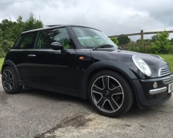 Susan is the lucky lady being treated to this 2004 MINI Cooper Pepper Pack in Astro Black with Sunroof