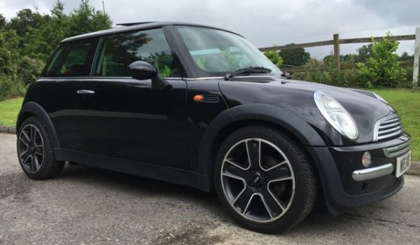 Susan is the lucky lady being treated to this 2004 MINI Cooper Pepper Pack in Astro Black with Sunroof